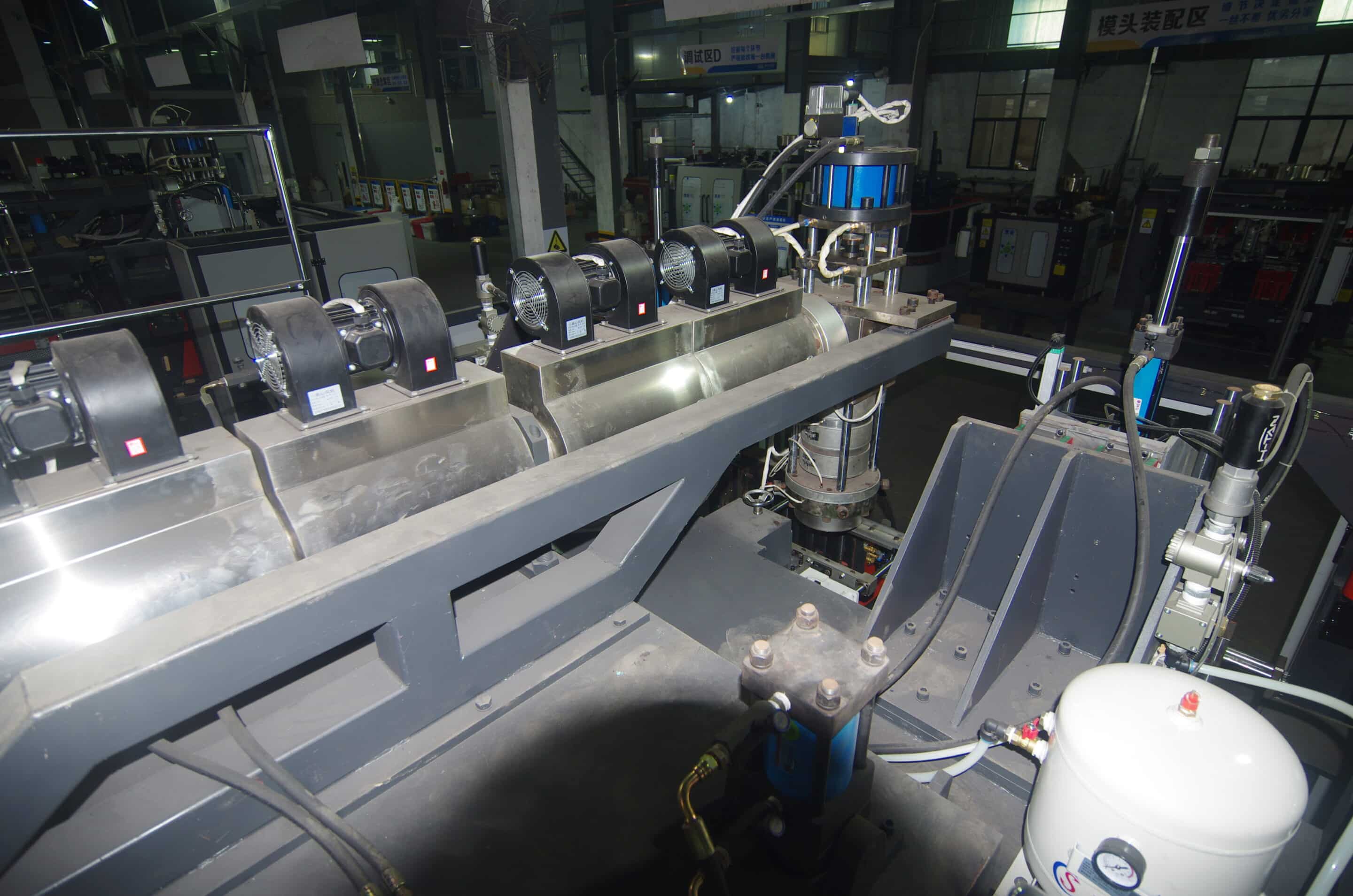 Extruder screw section with dual hoppers, band heaters, fans, and instrumentation on base frame