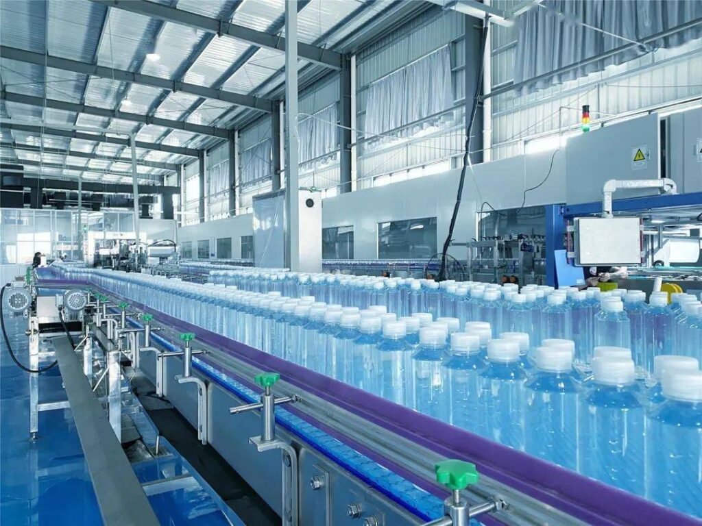 Mineral water bottle conveyor line in plastic packaging plant