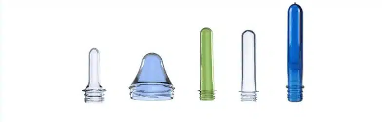 Assorted plastic bottle preforms with threaded necks in clear, green, and blue