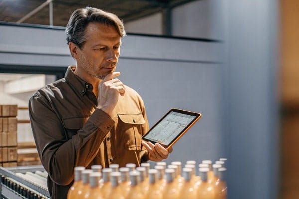 Confident machine owner with tablet in factory (ID#1)