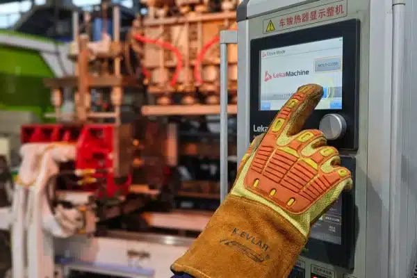 Industrial operator using HMI touch screen with heavy-duty safety gloves in glove-mode (ID#4)