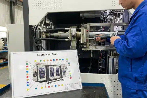 Routine Lubrication Maintenance Maintenance worker applying grease to machine toggle system following a lubrication guide map (ID#4)
