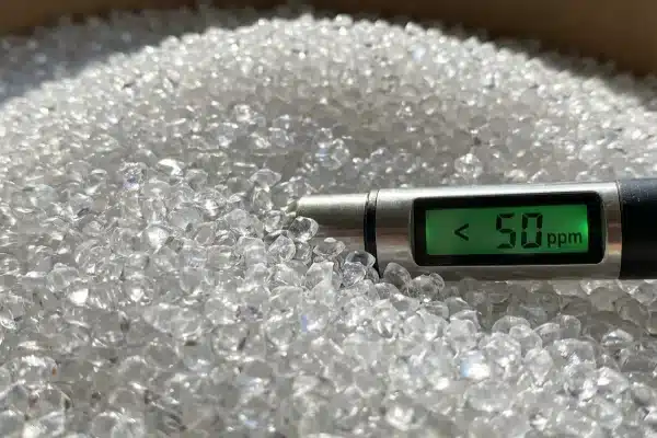 High quality PET resin granules with moisture meter displaying levels below 50 ppm (ID#4)