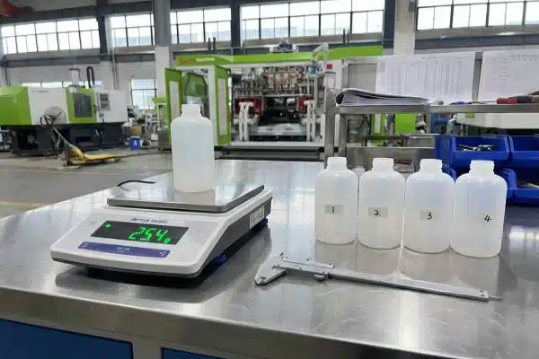 Precision Bottle Weight QC High-precision scale weighing a plastic bottle for multi-cavity weight balance QC testing (ID#5)