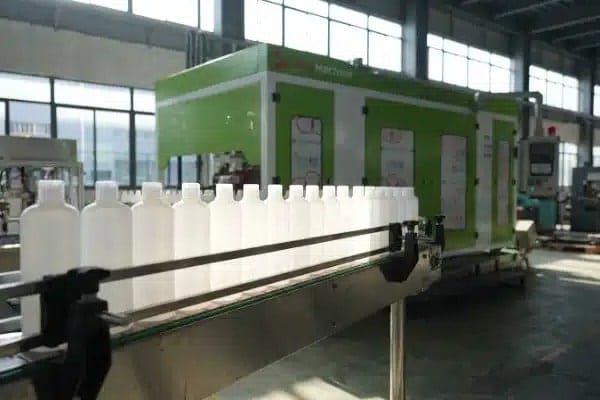 Identical plastic bottles on conveyor showing high production yield and quality (ID#5)